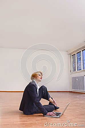 Moving to new office: Businesswoman with laptop Stock Photo