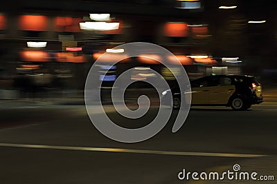 Moving yellow taxi is driving in night Barcelona city Stock Photo