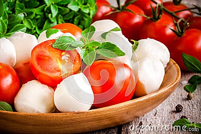 Mozzarella, organic cherry tomatoes and fresh basil closeup Stock Photo