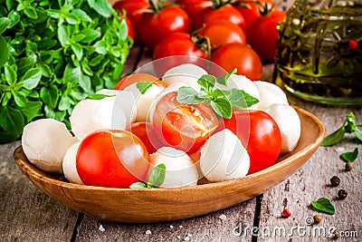 Mozzarella, organic cherry tomatoes, fresh basil and olive oil Stock Photo