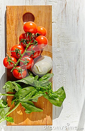 Mozzarella, organic cherry tomatoes and fresh basil Stock Photo