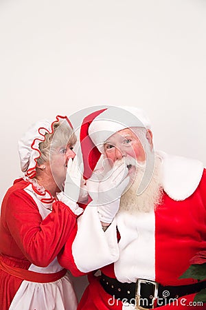 Mrs Claus tells Santa a secret Stock Photo