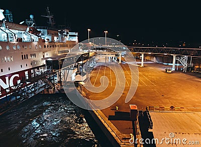 MS Rosella moored in the empty port at night seen from the leaving MS Silja Symphony Editorial Stock Photo