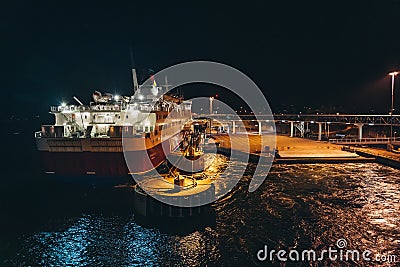 MS Rosella moored in the empty port at night seen from the leaving MS Silja Symphony Editorial Stock Photo