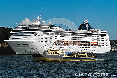 MSC Lirica cruise ship in the sea port of Oslo city with the local ferry boat at the foreground in in Oslo, Norway. Editorial Stock Photo