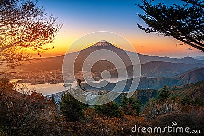 Mt. Fuji over Lake Kawaguchiko with autumn foliage at sunrise in Fujikawaguchiko, Japan Stock Photo