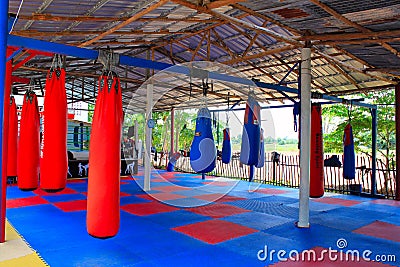 Muay Thai gym with boxing bags and colorful rubber floor at Ban Bung Sam Phan Nok, Phetchabun, Thailand. Stock Photo