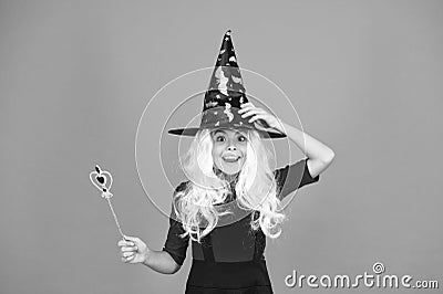 This is so much fun. small child witch hat. trick or treat. supernatural charmer. kid enchantress wave magic wand. happy Stock Photo