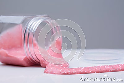 Mucus in the bank. Slime flows from the jar Stock Photo