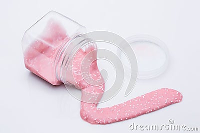 Pink slime flows out of the can on a white background Stock Photo