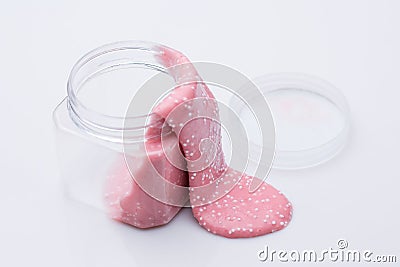 Pink slime flows out of the can on a white background Stock Photo