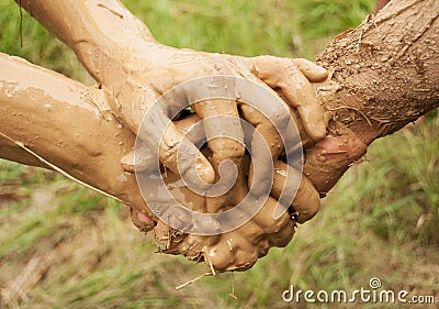 Mud hands connected together Stock Photo