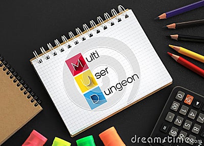 MUD Multi User Dungeon -multiplayer real-time virtual world, usually text-based or storyboarded, acronym text on notepad Stock Photo