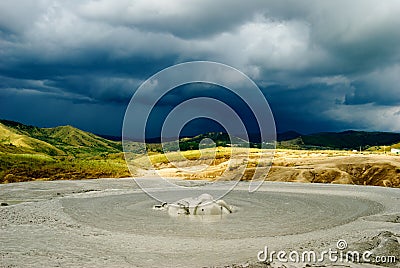 Mud volcano crater and dramatic background Stock Photo