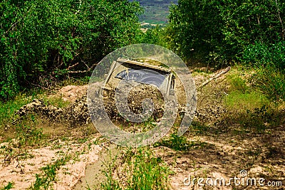 Mud and water splash in off-road racing. Mudding is off-roading through an area of wet mud or clay. Tracks on a muddy Stock Photo