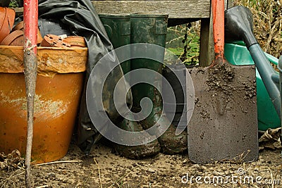 Muddy boots and spade. Stock Photo