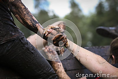 Muddy obstacle race runner in action. Mud run Stock Photo