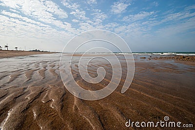 Muddy sand dark brown beach Stock Photo