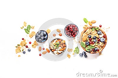 Muesli bowl and organic ingredients for healthy breakfast. Granola, nuts, blueberry, cranberry, oatmeal, greek yoghurt, whole Stock Photo