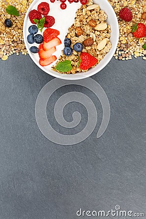 Muesli breakfast fruits yogurt strawberries cereals bowl slate p Stock Photo