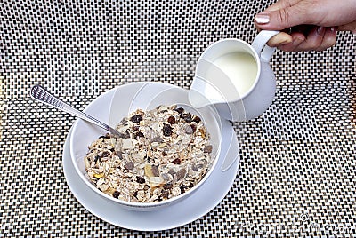 Muesli breakfast in package, milk and spoon Stock Photo