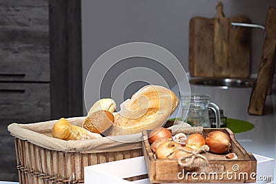 Muffin lies in the kitchen in a small basket, loaves, bread and rolls. Bad food, fullness, copy space Stock Photo