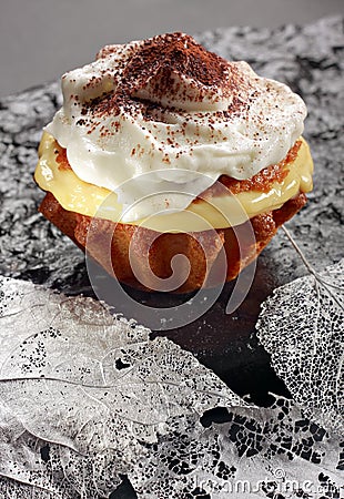 Muffin with pudding filling and whipped cream Stock Photo
