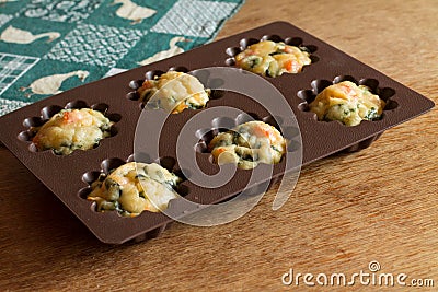 Muffin with salmon, spinach and cheese in silicone bakeware Stock Photo