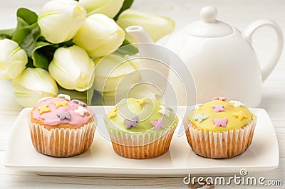 Muffins covered with icing sugar on white plate. Stock Photo