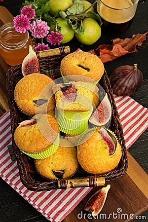 Muffins with fresh figs in a basket, on the table Stock Photo