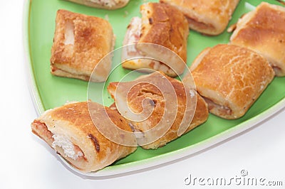 Muffins with ham and cheese on the green plate Stock Photo