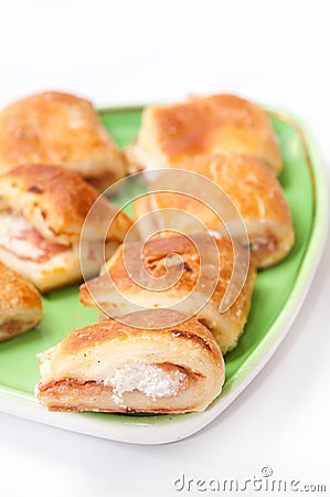 Muffins with ham and cheese on the green plate Stock Photo