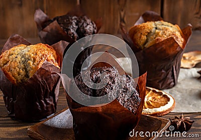Muffins on wooden plate with dryed oranges, apples and cinnamon Stock Photo