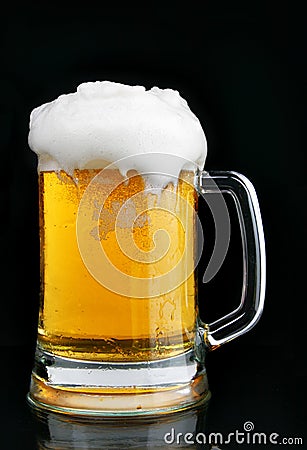 Mug of beer with froth Stock Photo