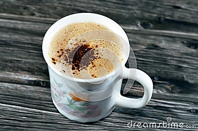 A mug of cappuccino topped with creamy froth and coffee, an espresso-based coffee drink that is traditionally prepared with Stock Photo