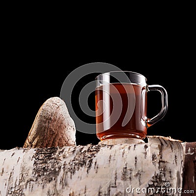 Mug with chaga tea or chaga coffee on a dark background with copy space. Natural organic drink. Strong antioxidant, enhances Stock Photo