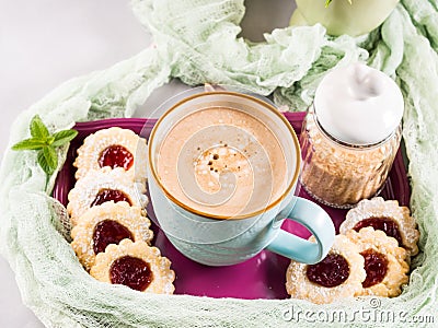 Mug of coffee cookies and flowers Stock Photo