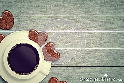 Mug of coffee with heart cookies lying on wooden table Stock Photo
