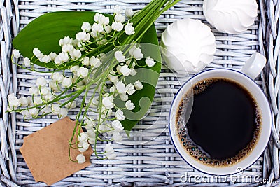 Mug of coffee, marshmallows and flowers lie on a blue table Stock Photo