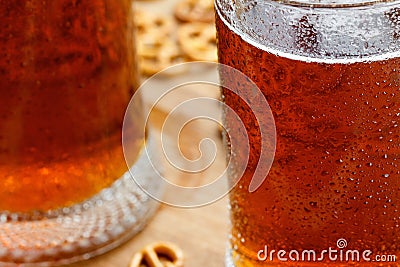 Mug of cold foamy beer with german brezel Stock Photo