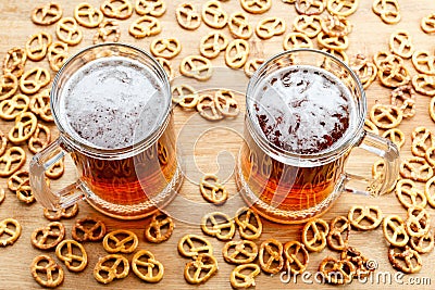 Mug of cold foamy beer with german brezel. Overhead view Stock Photo