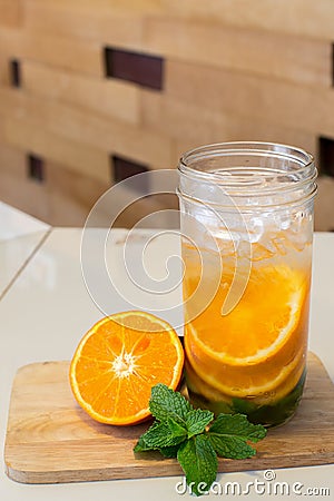 Mug delicious refreshing drink of orange fruit , infused water Stock Photo