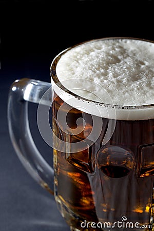 Mug of Fresh Beer with Foam Over Black Background Stock Photo