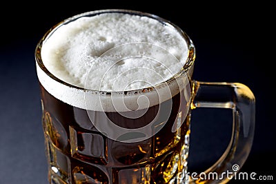 Mug of Fresh Beer with Foam Over Black Background Stock Photo