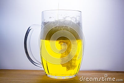 mug with light beer pour Stock Photo