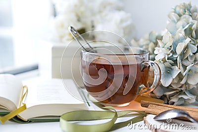 mug of tea, hydrangea, book, flowers Stock Photo