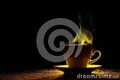 A mug with a warm drink and curly steam rising up, illuminated in red-yellow, orange on a black background Stock Photo