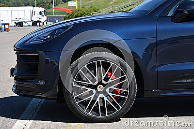 Mugello Circuit, Italy 23 September 2022: Detail of alloy black wheel with red caliper of a Porsche Cayenne Turbo on display in th Editorial Stock Photo