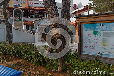 MUGLA, TURKEY: Monument of a man reading a newspaper on the street in the center of Mugla. Editorial Stock Photo