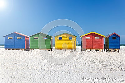 Muizenberg beach with white sand and colorful wooden cabins in Cape Town Stock Photo